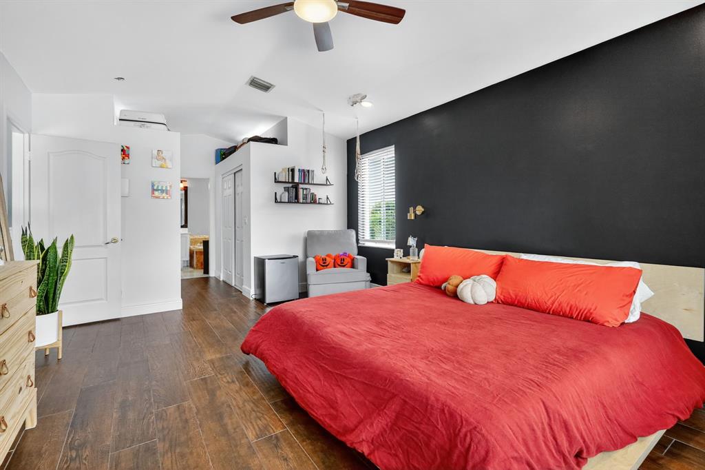 18676 Southwest 16th Street Pembroke Pines, FL 33029 - Photo 35 of 61 a bedroom with a bed and a flat screen tv