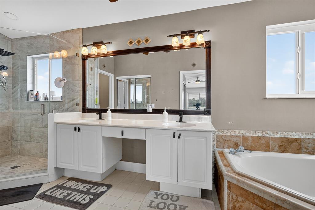 18676 Southwest 16th Street Pembroke Pines, FL 33029 - Photo 37 of 61 a spacious bathroom with a sink mirror and a bathtub