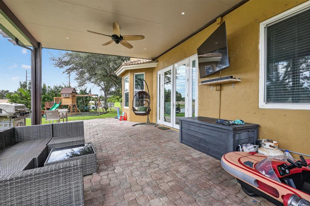 18676 Southwest 16th Street Pembroke Pines, FL 33029 - Photo 47 of 61 a living room with furniture and a floor to ceiling window