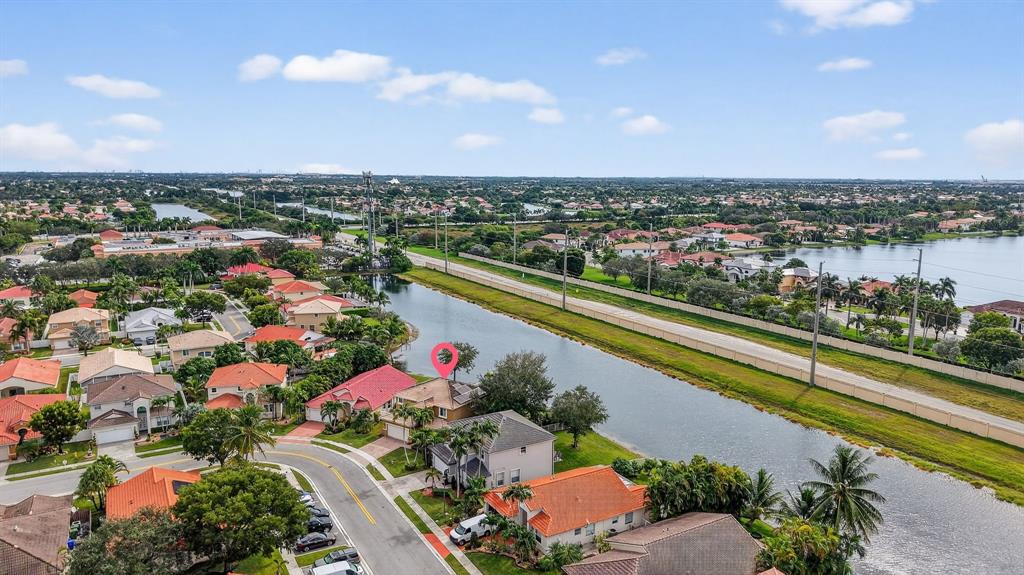 18676 Southwest 16th Street Pembroke Pines, FL 33029 - Photo 56 of 61 an aerial view of a city with lots of residential buildings ocean and mountain view in back