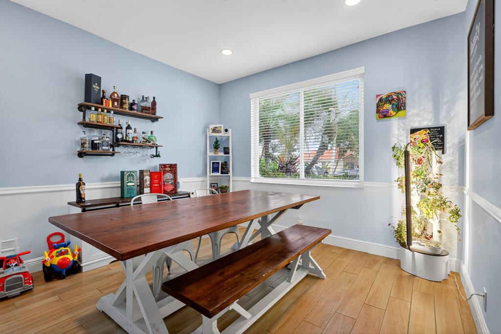 18676 Southwest 16th Street Pembroke Pines, FL 33029 - Photo 6 of 61 a reading room with furniture wooden floor and a potted plant