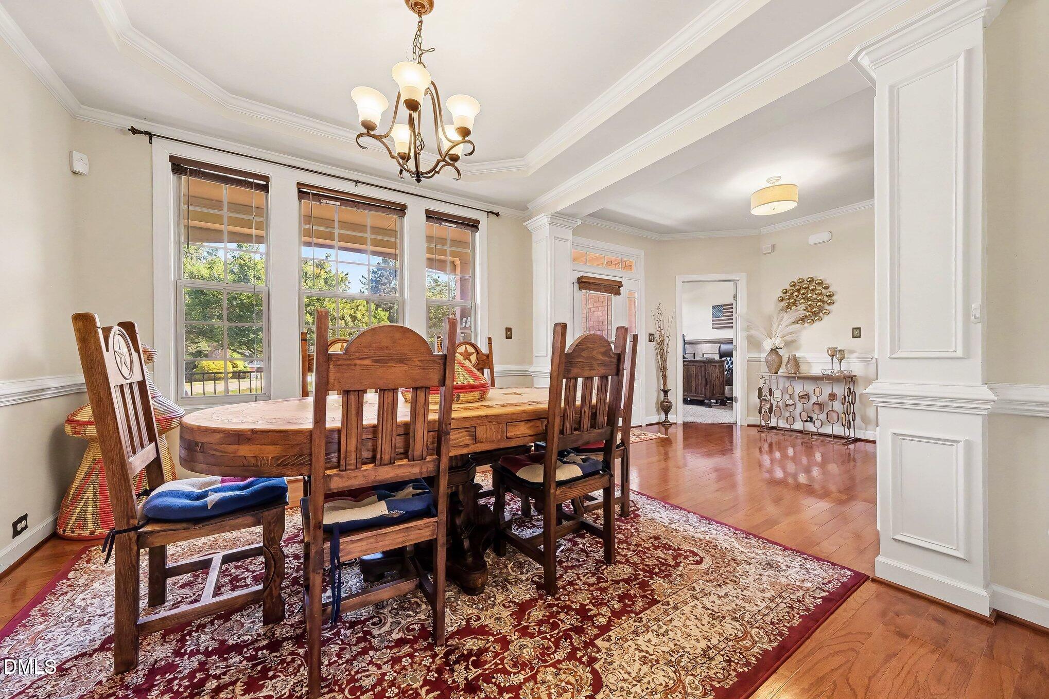 4000 Banks Stone Drive Raleigh, NC 27603 - Photo 12 of 60 a dining room with furniture a chandelier and wooden floor