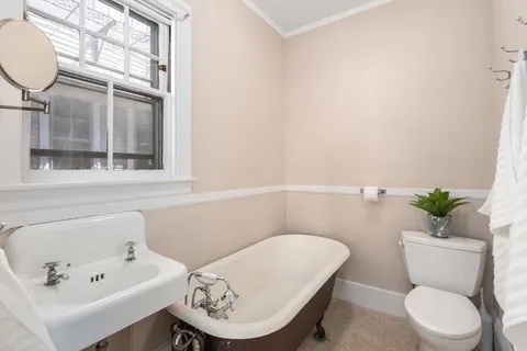 a white toilet sitting next to a bathroom sink