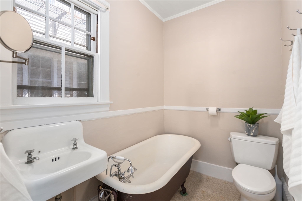 192 Upland Road Cambridge, MA 02140 - Photo 13 of 29 a white toilet sitting next to a bathroom sink