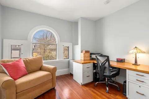 a view of workspace with wooden floor and windows