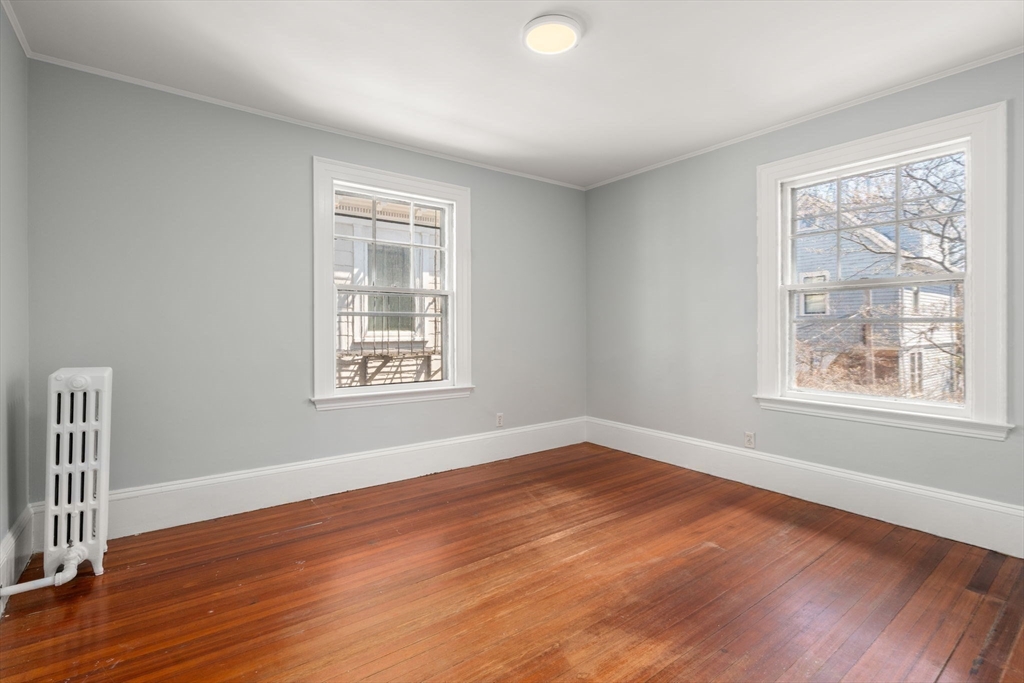 192 Upland Road Cambridge, MA 02140 - Photo 16 of 29 a view of an empty room with wooden floor and a window