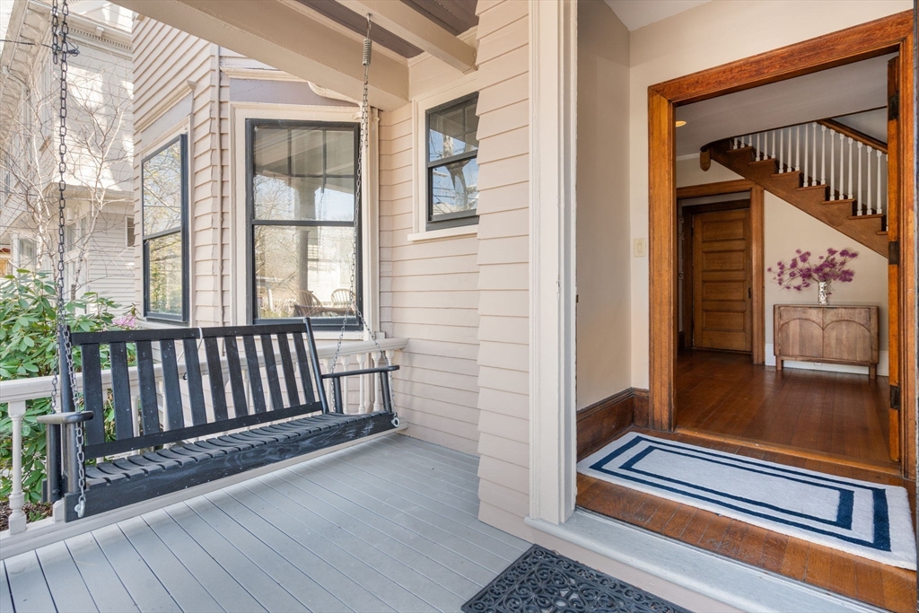 192 Upland Road Cambridge, MA 02140 - Photo 2 of 29 a view of a balcony with furniture and wooden floor