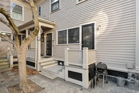a view of a house with a table and chairs