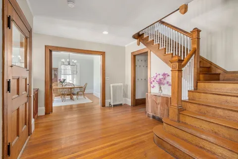 a view of a hallway view with wooden floor and staircase