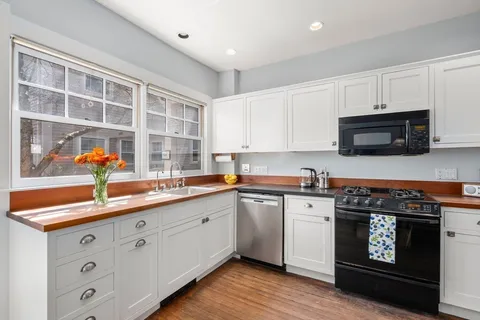 a kitchen with stainless steel appliances a stove a sink and a microwave