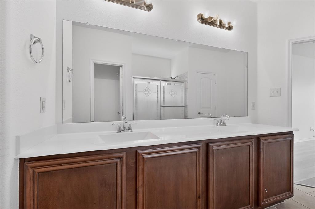 426 Harding Lane Lavon, TX 75166 - Photo 26 of 40 Dual vanity featuring wood-finish cabinetry, white countertops, and chrome fixtures