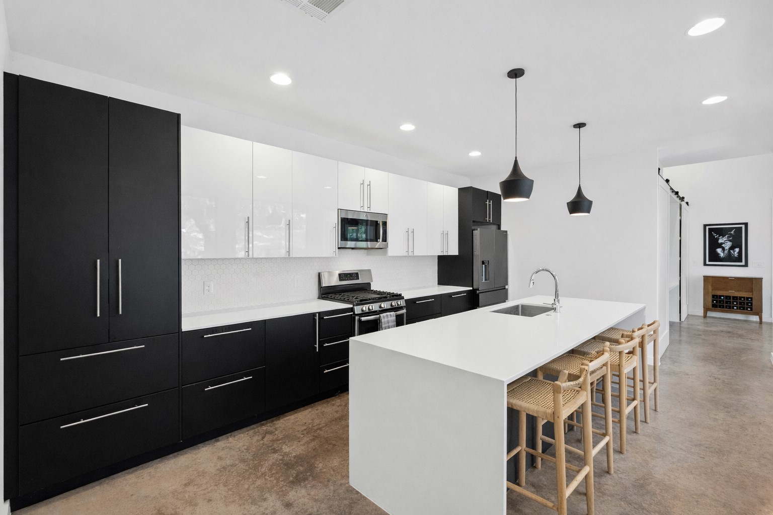a kitchen with a stove a refrigerator and a sink