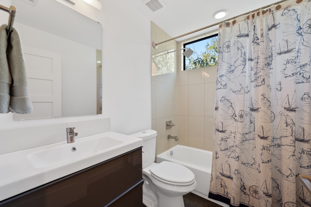 1005 Cardinal Lane, Unit B Austin, TX 78704 - Photo 11 of 17 a bathroom with a sink and a toilet