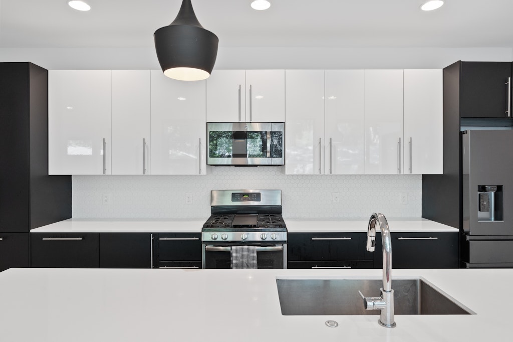 1005 Cardinal Lane, Unit B Austin, TX 78704 - Photo 3 of 17 a kitchen with stainless steel appliances granite countertop a sink a stove a refrigerator and cabinets
