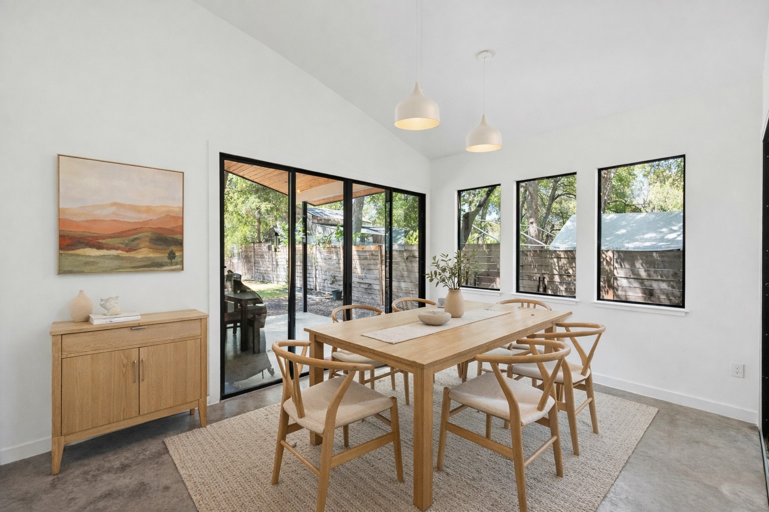 1005 Cardinal Lane, Unit B Austin, TX 78704 - Photo 5 of 17 a view of a dining room with furniture large windows and wooden floor