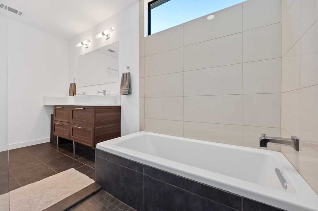 1005 Cardinal Lane, Unit B Austin, TX 78704 - Photo 9 of 17 a bathroom with a bathtub and sink