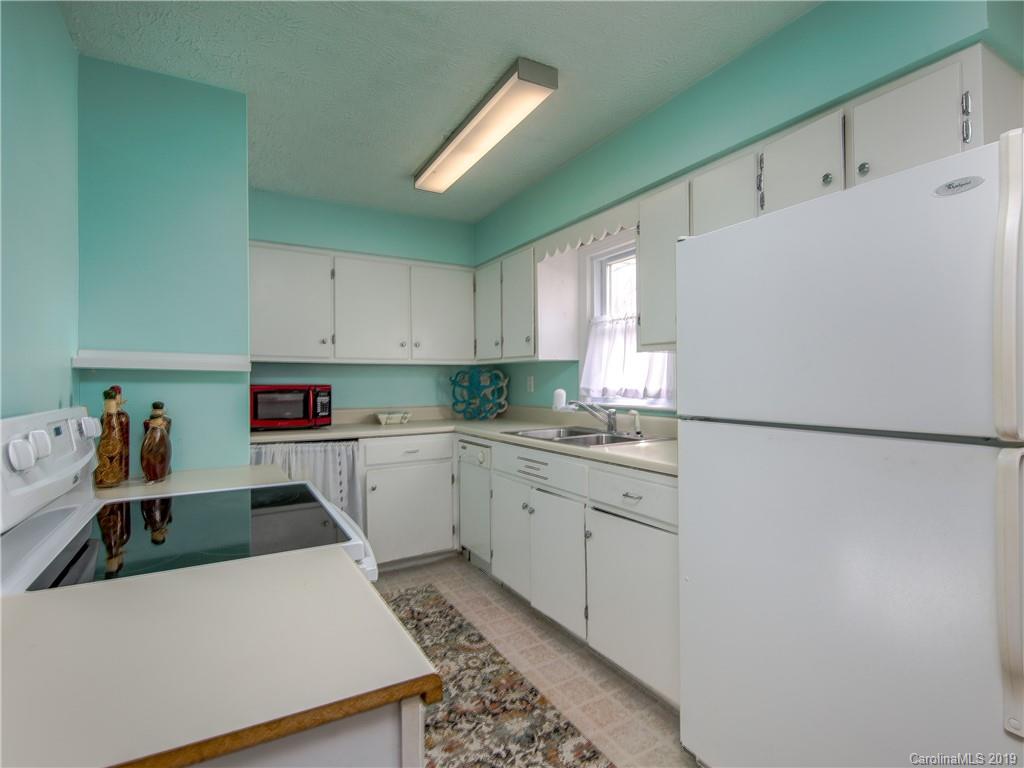 190 Brickyard Road Etowah, NC 28729 - Photo 5 of 15 a kitchen with a refrigerator a sink and white cabinets