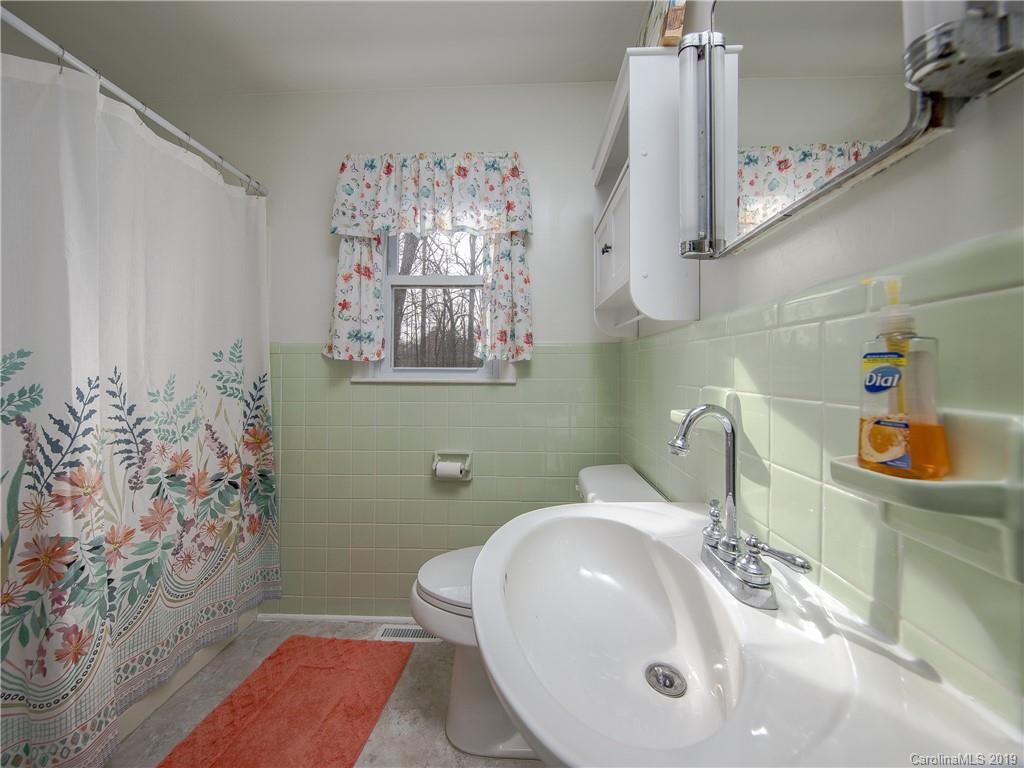 190 Brickyard Road Etowah, NC 28729 - Photo 6 of 15 a bathroom with a sink a toilet and mirror