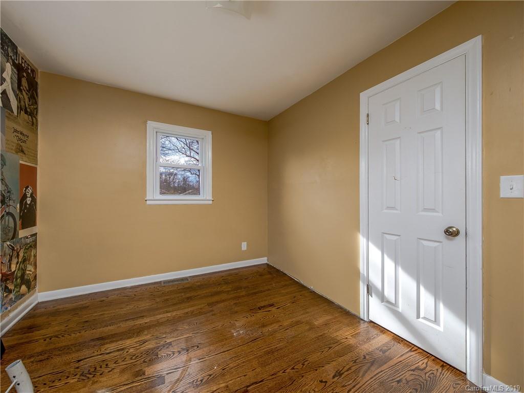 190 Brickyard Road Etowah, NC 28729 - Photo 9 of 15 a view of an empty room with wooden floor and a window