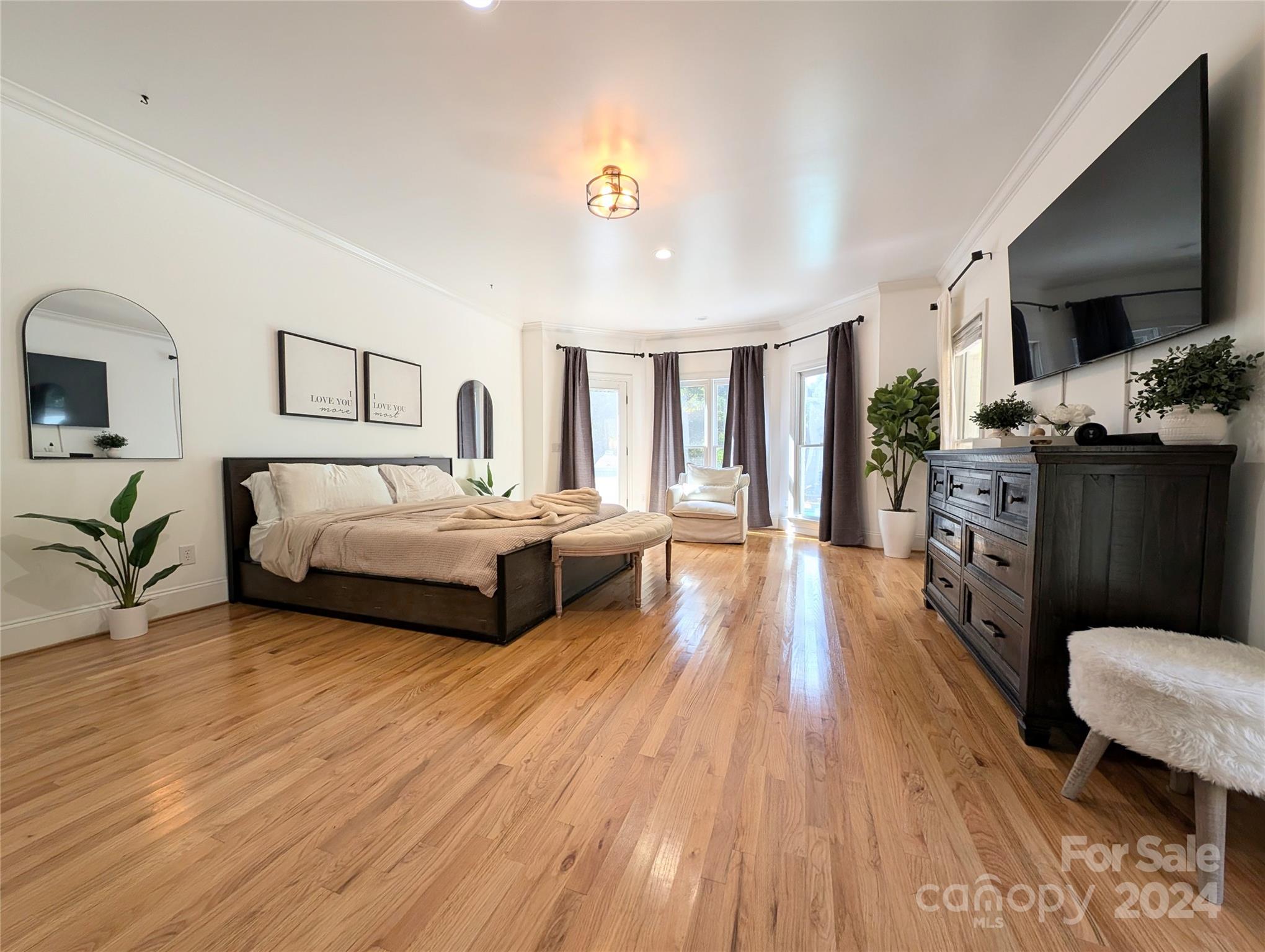 640 Amberly Crossing Fort Mill, SC 29708 - Photo 17 of 45 a spacious bedroom with a bed a couch and dresser