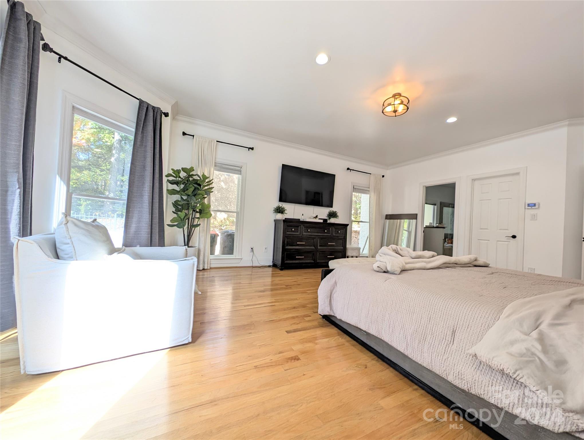 640 Amberly Crossing Fort Mill, SC 29708 - Photo 18 of 45 a spacious bedroom with a large bed and a flat screen tv