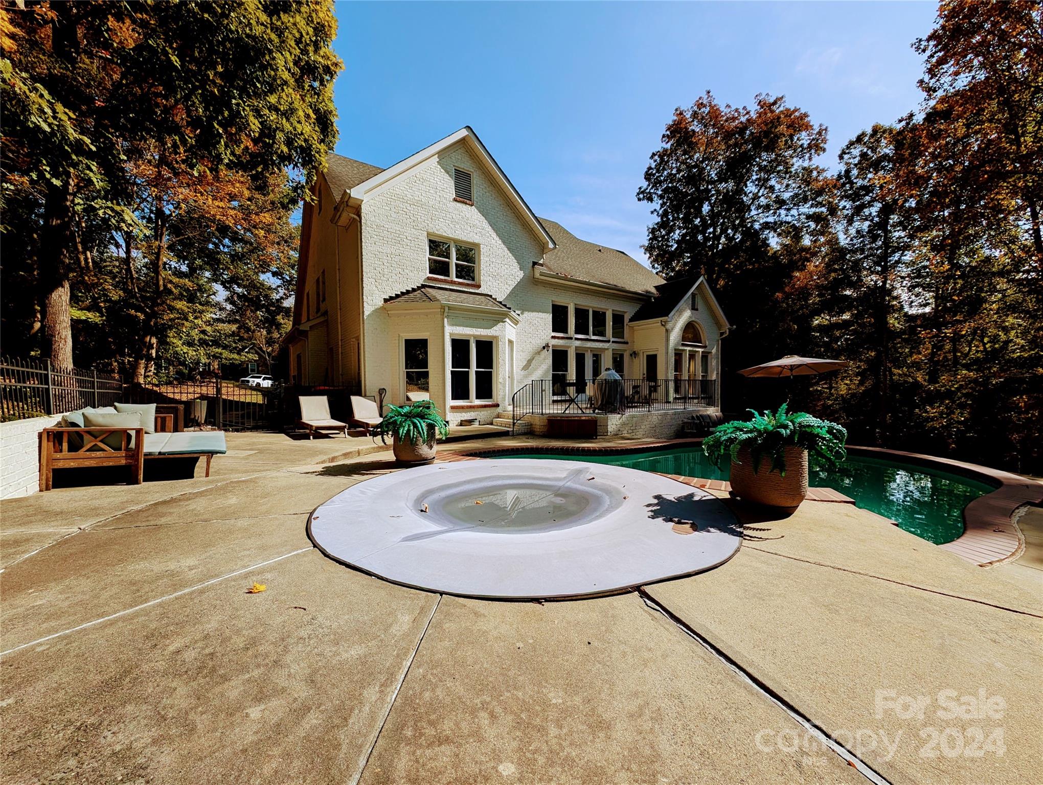 640 Amberly Crossing Fort Mill, SC 29708 - Photo 41 of 45 a view of a white house with a swimming pool and a fire pit