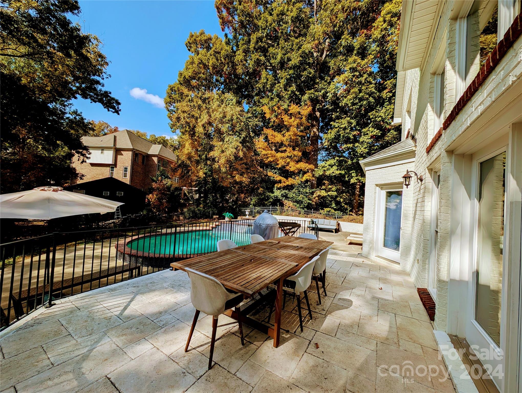 640 Amberly Crossing Fort Mill, SC 29708 - Photo 45 of 45 a view of a patio with a table and chairs under an umbrella with large trees
