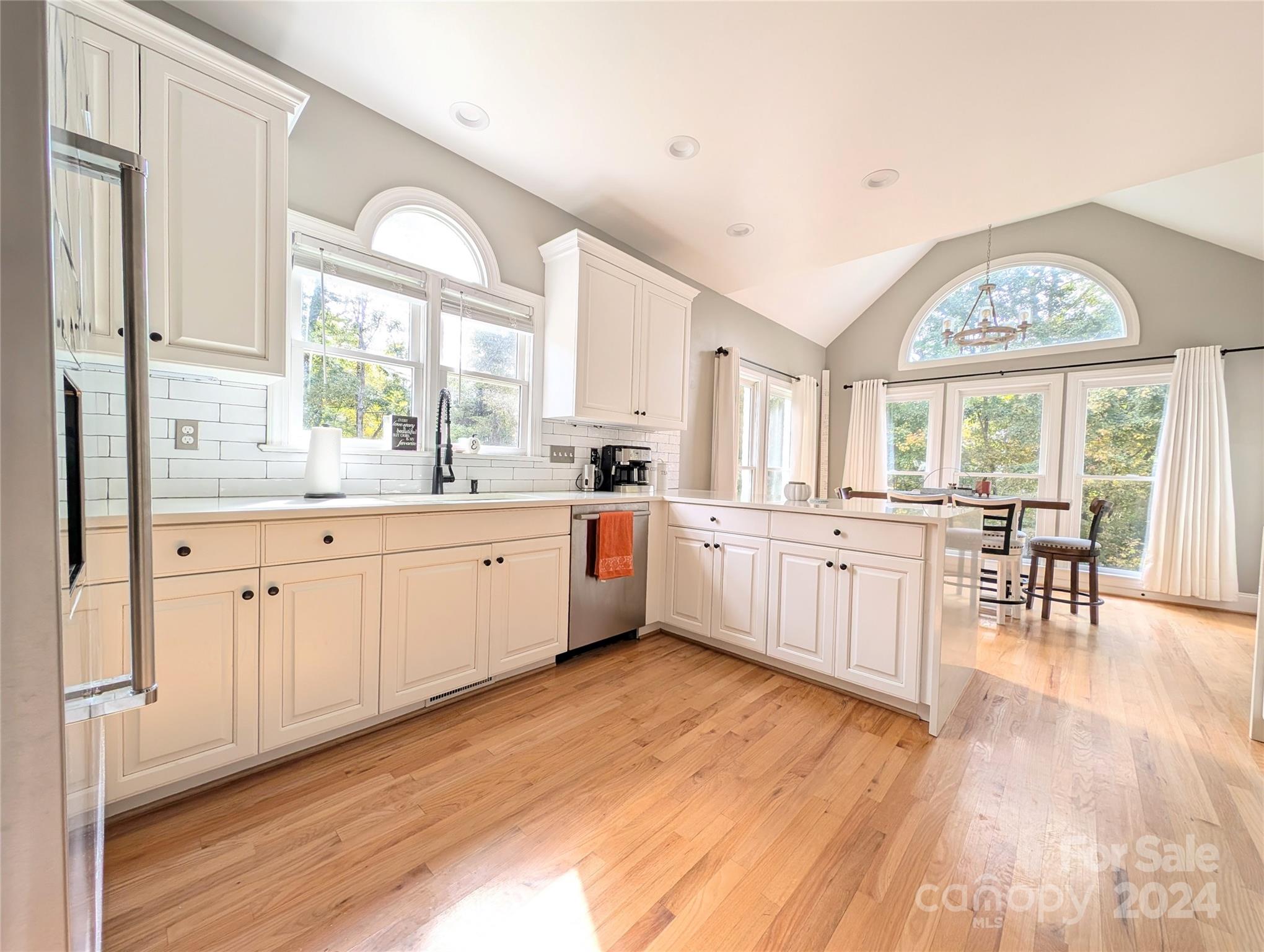640 Amberly Crossing Fort Mill, SC 29708 - Photo 7 of 45 a large white kitchen with cabinets a sink a window and stainless steel appliances