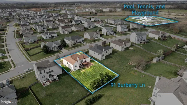an aerial view of a residential houses with outdoor space