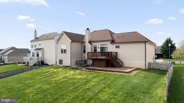 a view of a house with a yard and sitting area