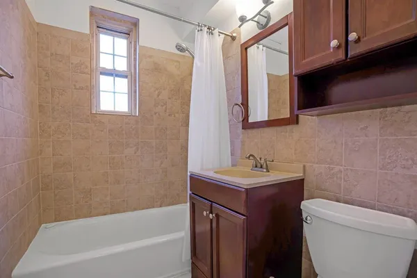 a bathroom with a sink a toilet and bathtub