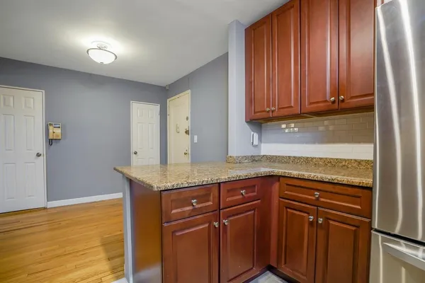 a kitchen with granite countertop cabinets and window