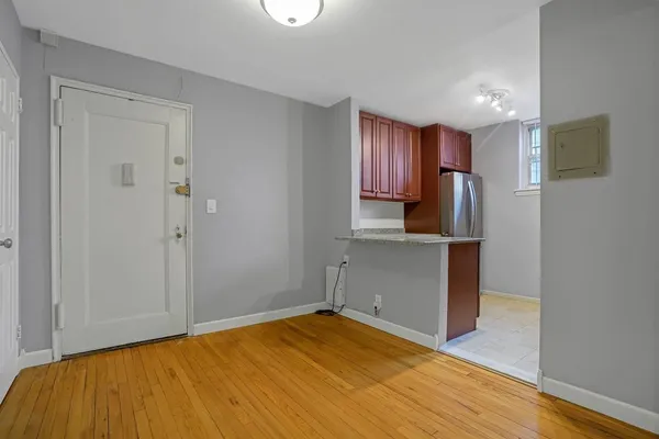 a view of empty room with wooden floor