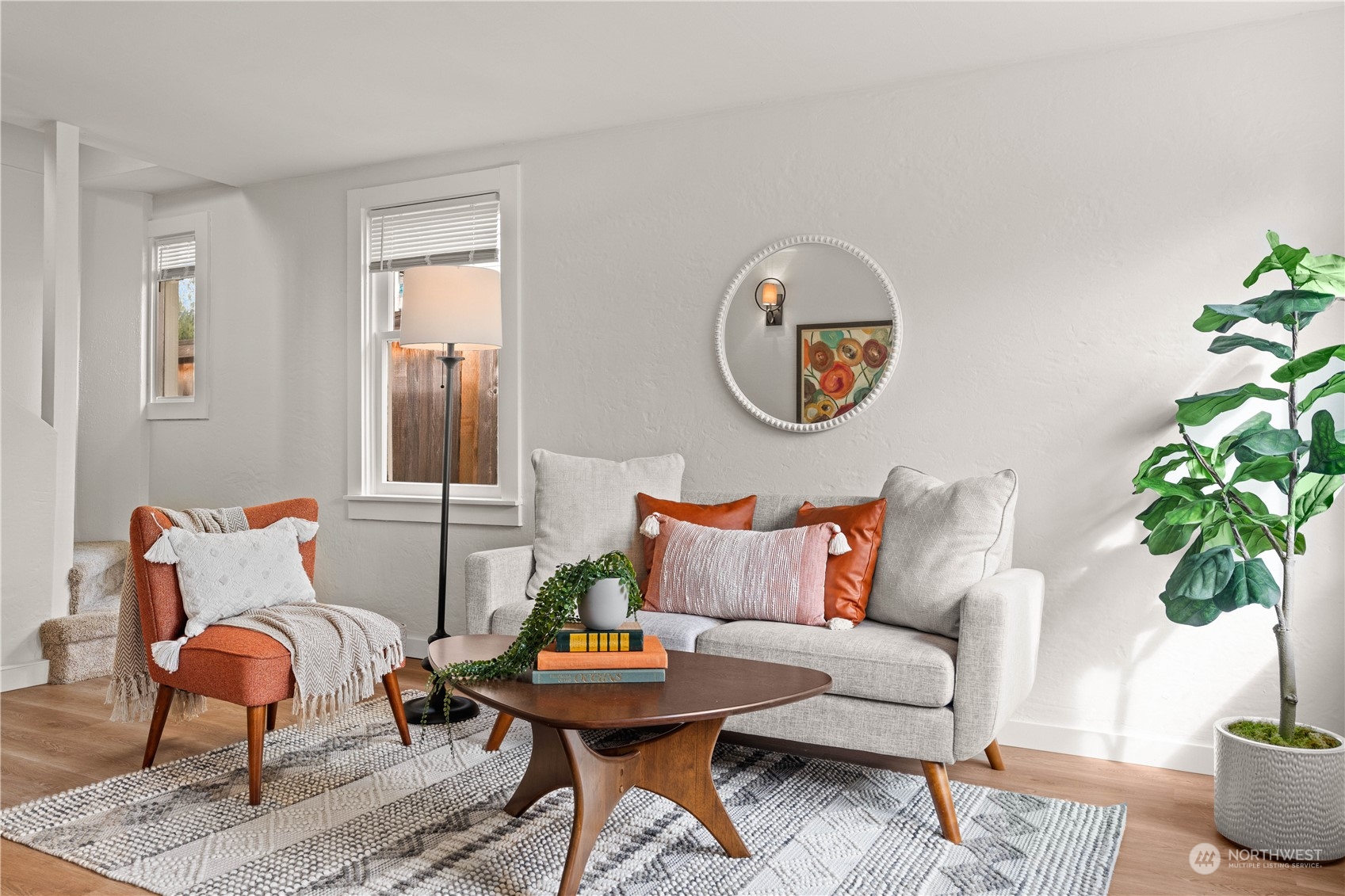 9721 Fremont Avenue North Seattle, WA 98103 - Photo 11 of 27 a living room with furniture a rug and a potted plant