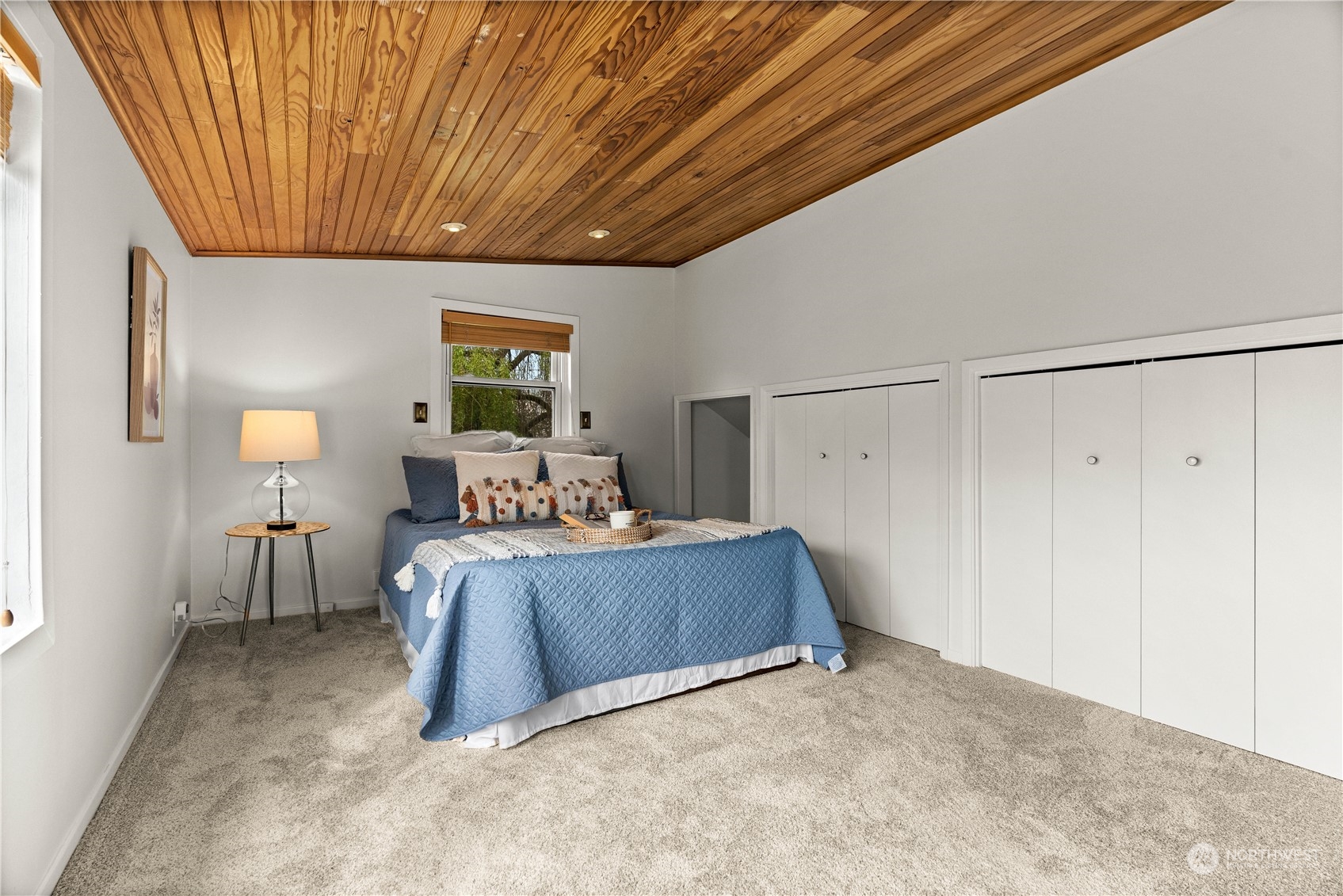 9721 Fremont Avenue North Seattle, WA 98103 - Photo 12 of 27 a bed room with a bed and a chandelier