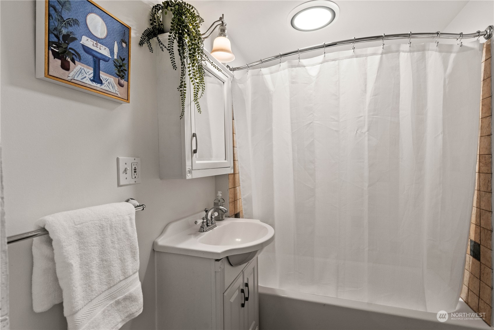 9721 Fremont Avenue North Seattle, WA 98103 - Photo 15 of 27 a bathroom with a sink and mirror