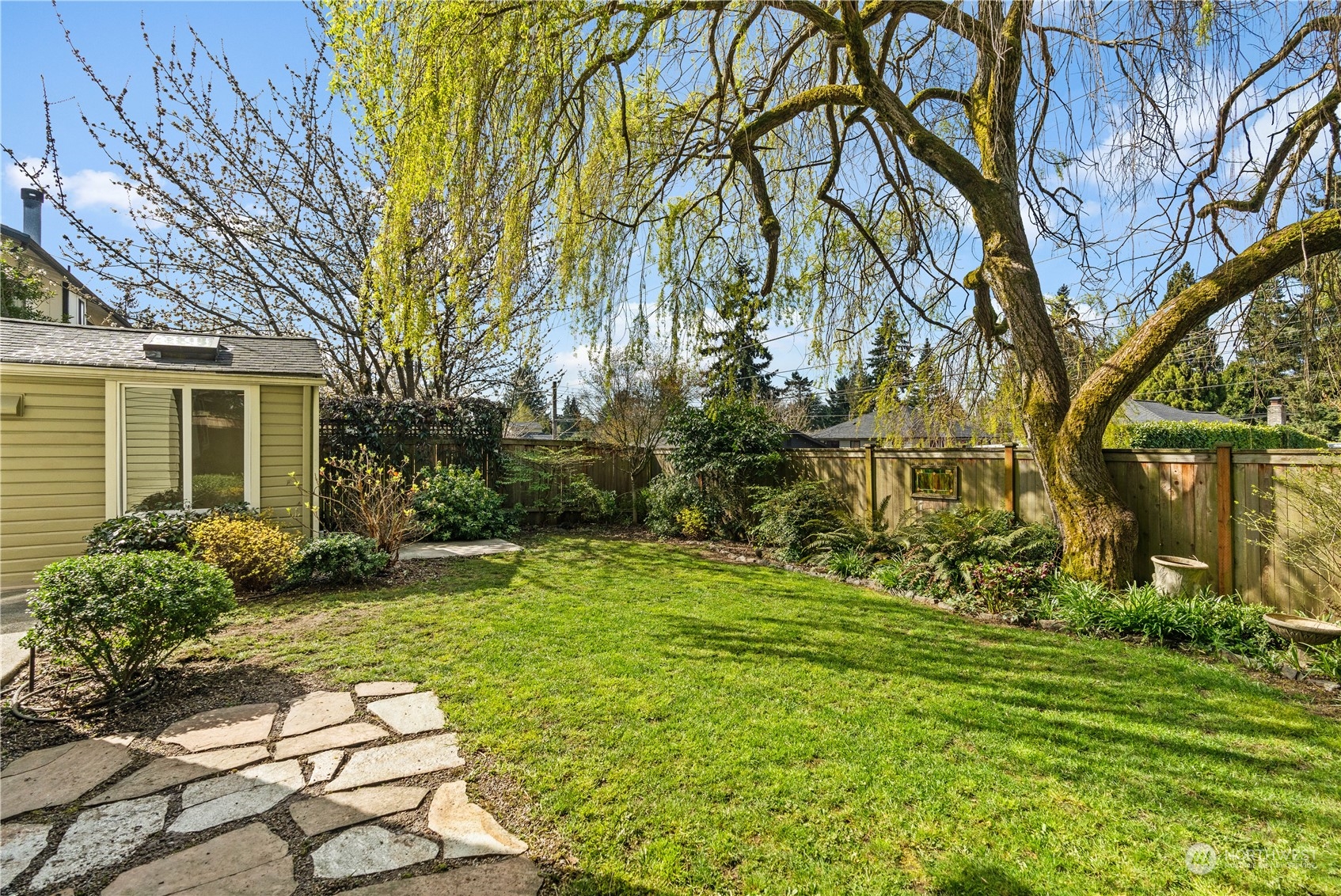 9721 Fremont Avenue North Seattle, WA 98103 - Photo 25 of 27 a backyard of a house with lots of green space