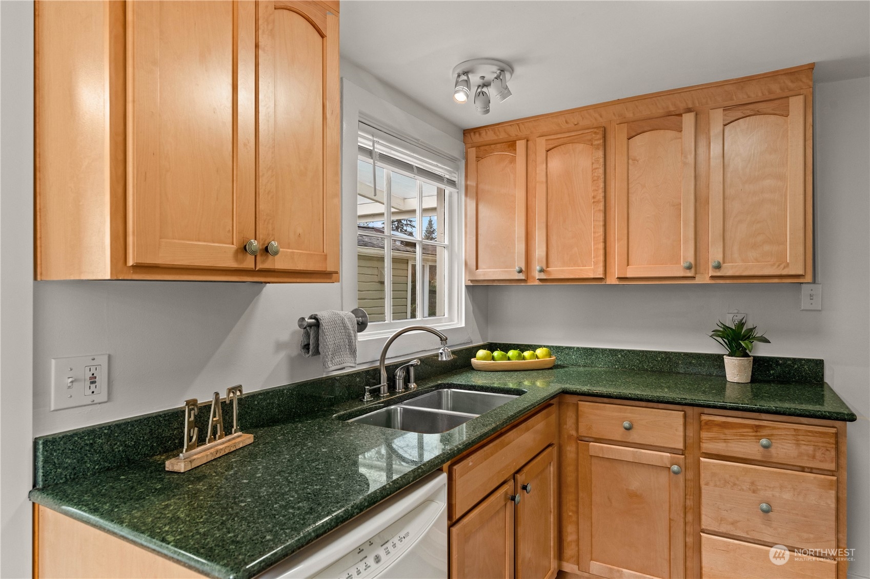 9721 Fremont Avenue North Seattle, WA 98103 - Photo 4 of 27 a kitchen with granite countertop a sink a stove and cabinets