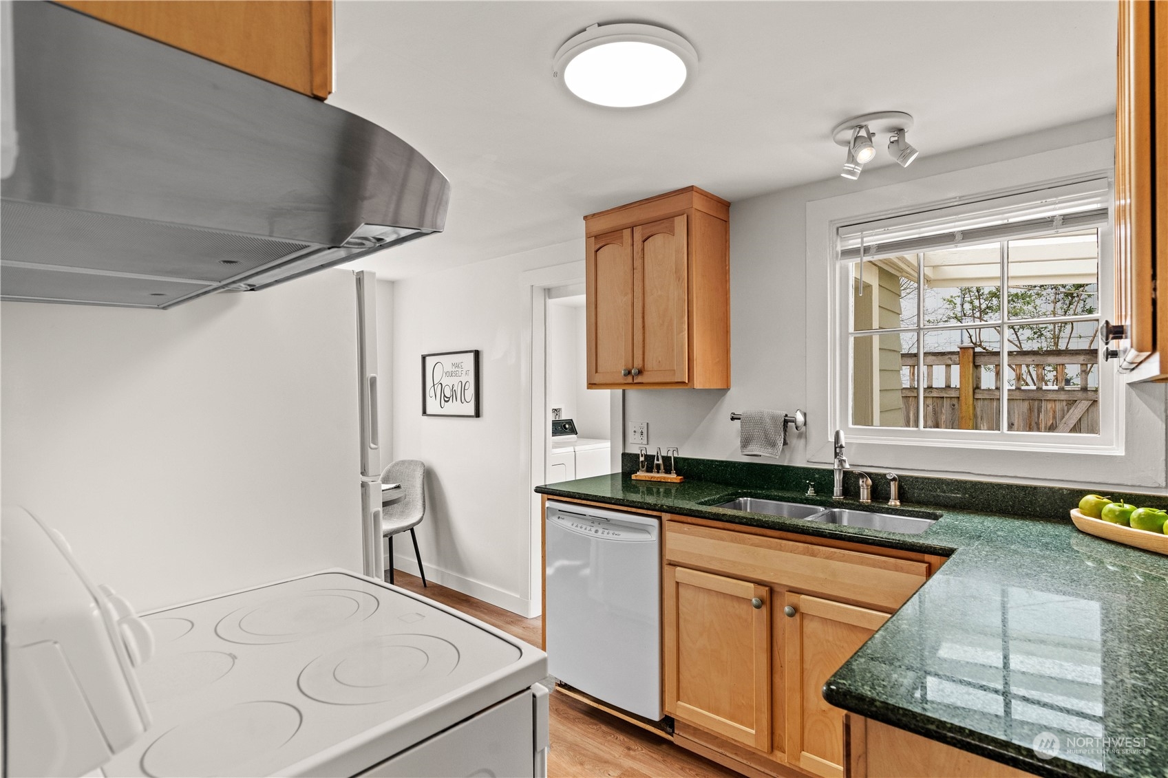 9721 Fremont Avenue North Seattle, WA 98103 - Photo 5 of 27 a kitchen with granite countertop a sink a stove and cabinets