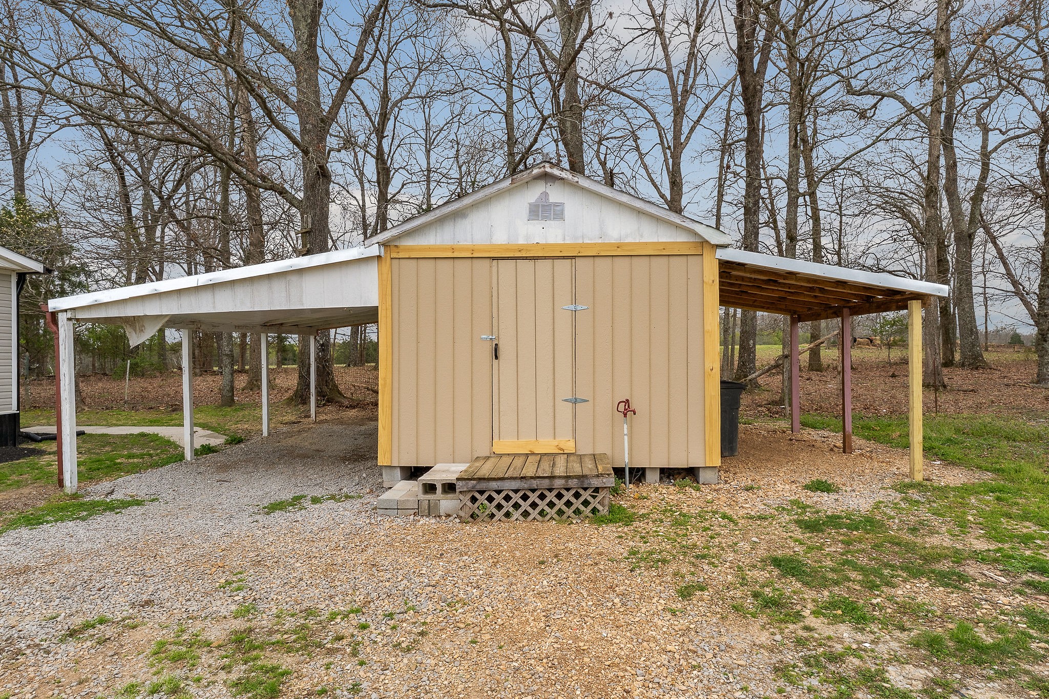 479 Old Bildad Road Smithville, TN 37166 - Photo 23 of 30 a backyard of a house with plants and large tree