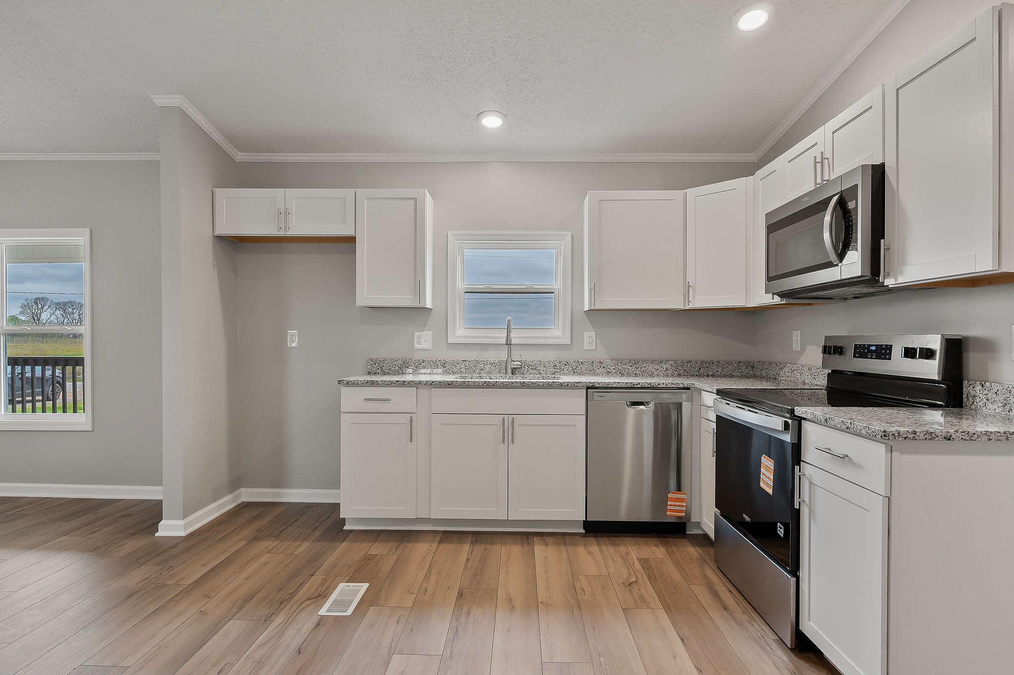 479 Old Bildad Road Smithville, TN 37166 - Photo 7 of 30 a kitchen with stainless steel appliances granite countertop a stove a sink and a microwave