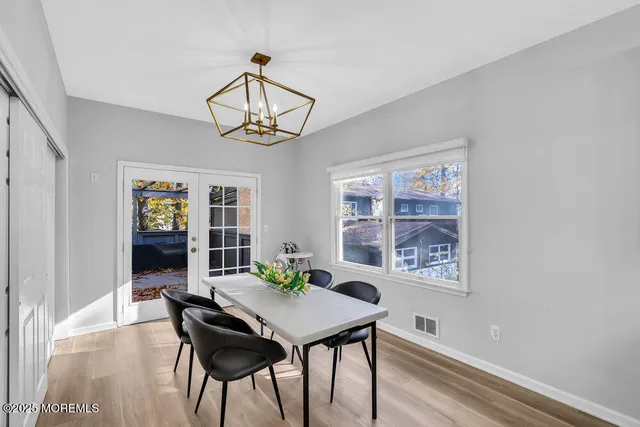 a bedroom with two beds and painting on the wall