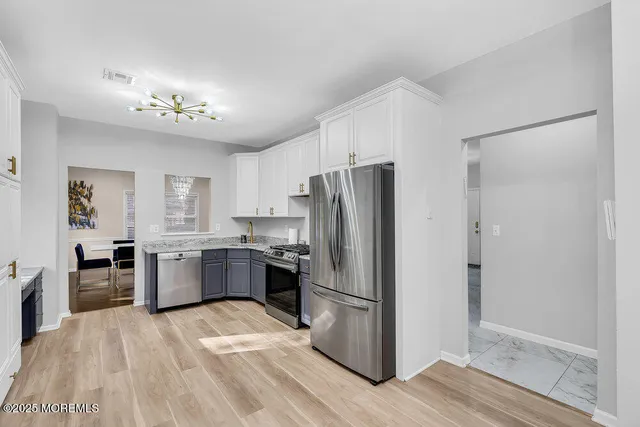 a bedroom with two beds and lamp