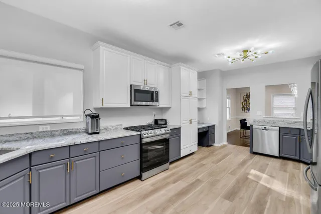 a bedroom with two beds and painting on the wall