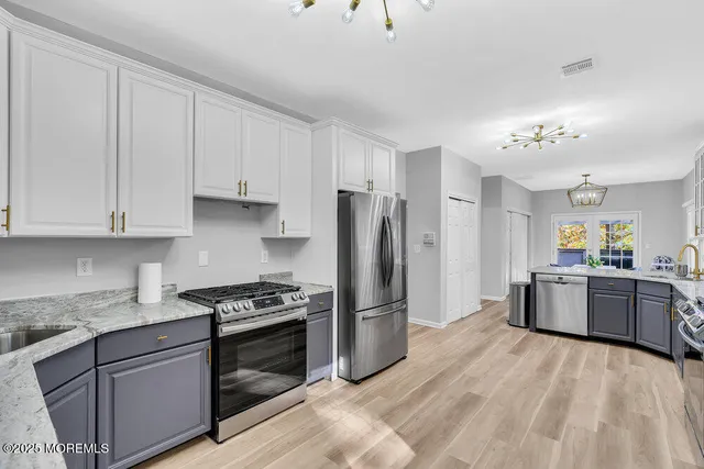 a view of a hallway with wooden floor and a window