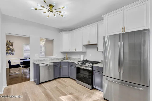 a backyard of a house with barbeque oven table and chairs