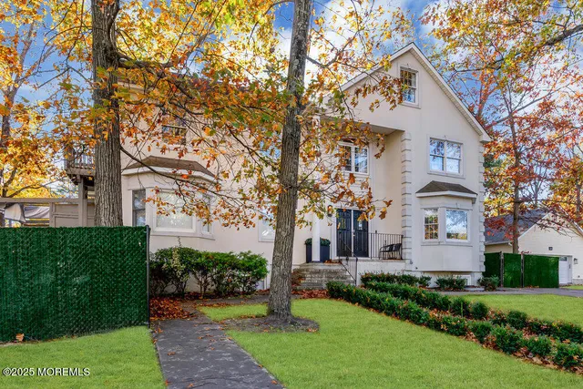 a kitchen with granite countertop a stove a sink a kitchen island with a dining table and chairs