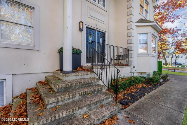 a kitchen with stainless steel appliances granite countertop a refrigerator a sink a stove and white cabinets