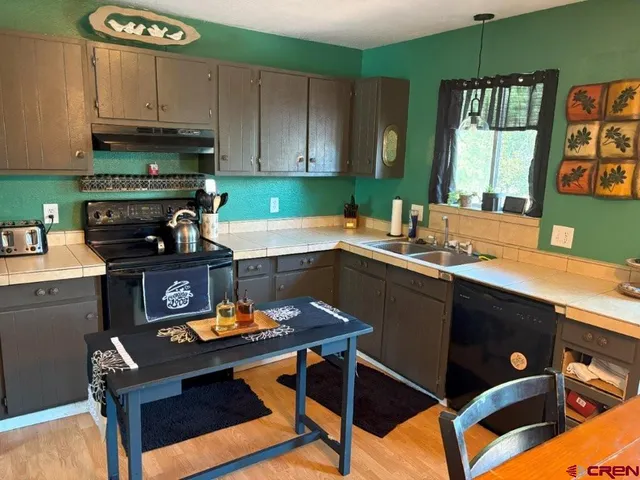 a kitchen with a sink cabinets and window