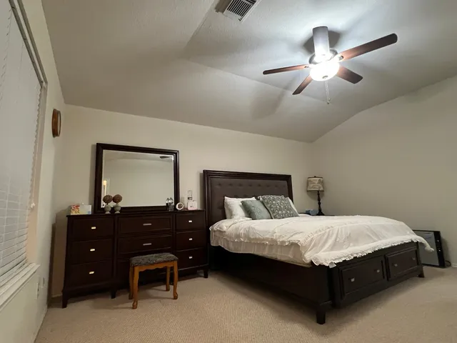a bedroom with a bed and a dresser